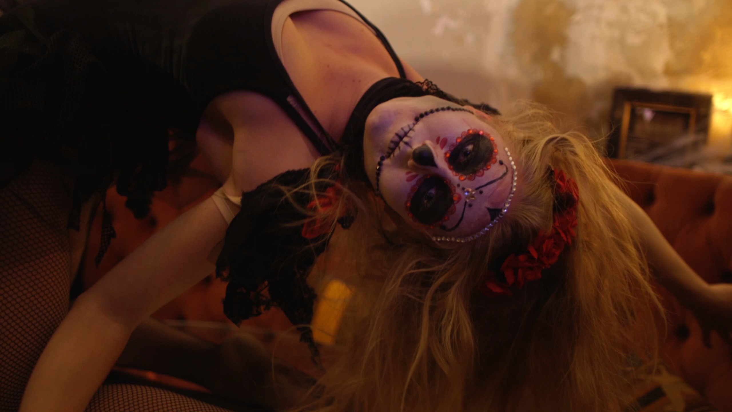 person with dia de muertos face paint